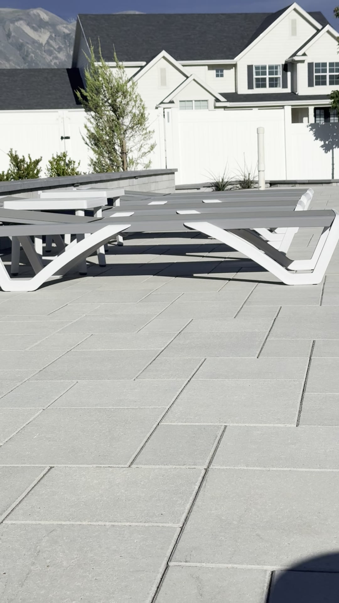 Gray modular paver patio with lounge seating, Wasatch mountain backdrop